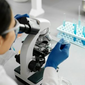 Medical professional using a microscope