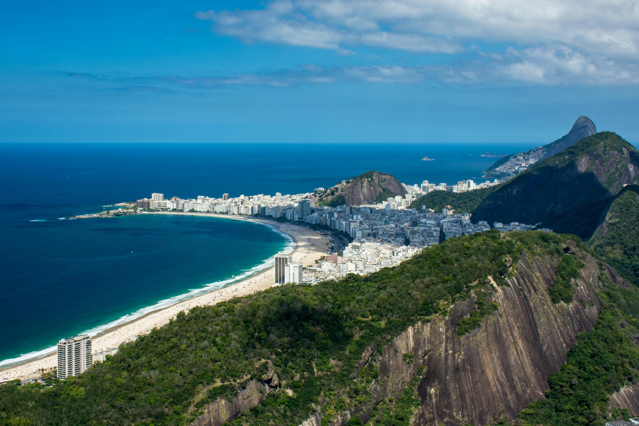 reen and Brown Mountains Beside the City Buildings near the Ocean