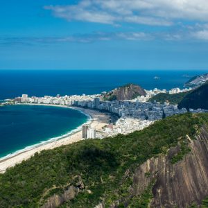 reen and Brown Mountains Beside the City Buildings near the Ocean