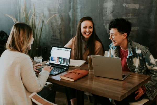 3 people in a small meeting room
